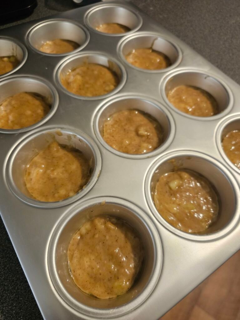 Dividing the batter into the muffin tray. I think we got this from Ikea. 😊
